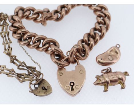 GOLD JEWELLERY comprising 9ct gold curb link bracelet with heart shaped padlock, two 9ct gold charms, and a 9ct gold gate lin