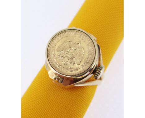 18K GOLD EMKA COIN SET RING WATCH, the hinged lid set with coin marked 'Estados Unidos Mexicanos' revealing watch dial, stamp