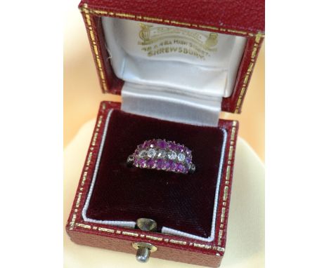 DIAMOND &amp; RUBY TRIPLE ROW RING comprising five diamonds and sixteen rubies, ring size K, 1.8gms, in square burgundy ring 