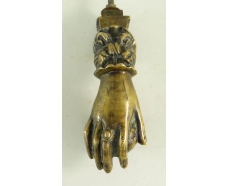 BBC BARGAIN HUNT LOT:&nbsp;VICTORIAN BRASS HAND DOOR KNOCKER, the ringed hand with ribbon cuff and holding a fruit, 15cms lon