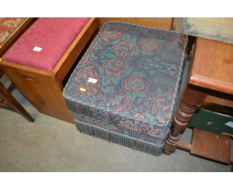 A floral upholstered pouffe