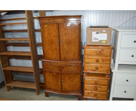 A walnut bow front drinks cabinet fitted two drawers.