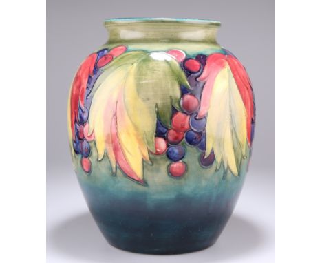 WALTER MOORCROFTA LARGE "LEAF AND BERRY" PATTERN POTTERY VASE, CIRCA 1950, the ovoid body tubelined and hand-painted with sty