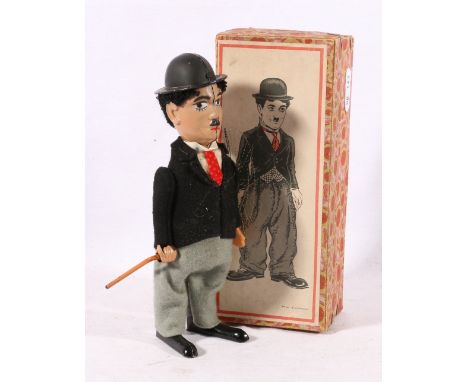 Schuco clockwork figure of Charlie Chaplin 18cm tall in original box  CONDITION REPORT: Key appears old with folded trunk, no