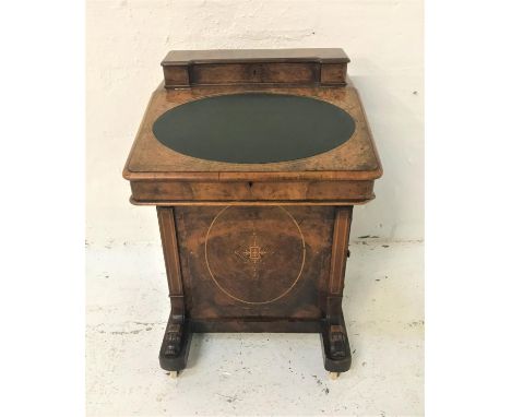 VICTORIAN FIGURED WALNUT AND INLAID DAVENPORTwith a fitted inverted breakfront stationary box above a lift up lid with an ova