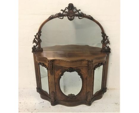 VICTORIAN WALNUT CREDENZAthe arched mirror back with a pierced and carved frame above a serpentine base with three mirrored d
