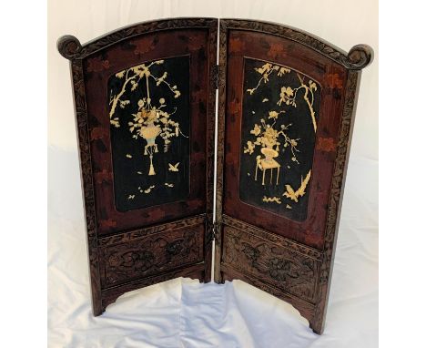 CHINESE EBONISED FOLDING SCREENwith floral and scroll border, the central panels decorated with mother of pearl floral scenes