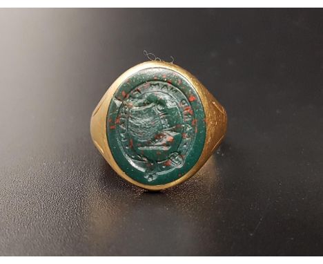 BLOODSTONE SEAL RINGin unmarked high carat gold, the seal depicting the Smyth family crest with central arm from the shoulder