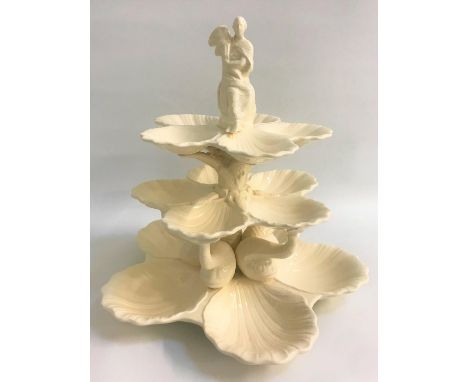 ROYAL CREAMWARE SHELLFISH STANDwith a seated lady finial above three graduated tiers, each with five scallop shells, the lowe