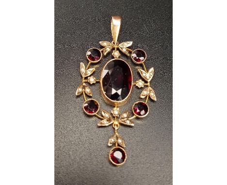 ATTRACTIVE EDWARDIAN GARNET AD SEED PEARL PENDANTthe central oval cut garnet in round garnet and seed pearl surround, with fu