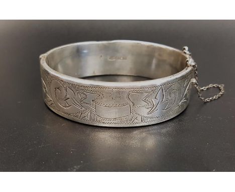 VICTORIAN STYLE SILVER BANGLEthe hinged bangle with engraved scroll decoration and safety chain, Birmingham 1963, maker C P S