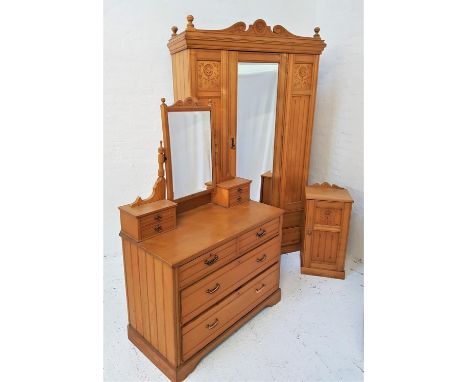 EDWARDIAN LIGHT OAK BEDROOM SUITEcomprising a wardrobe with an arched carved pediment above a central single mirror door with
