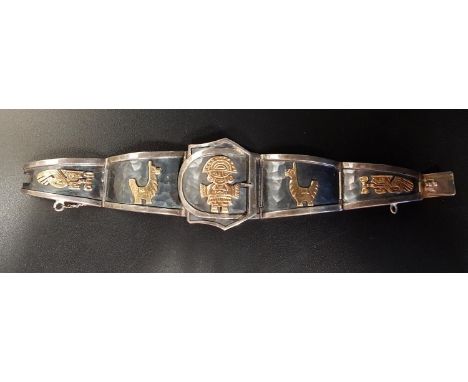 PERUVIAN SILVER AND GOLD BRACELETthe graduated silver links with applied eighteen carat gold traditional motifs, also with bu