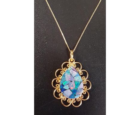 MOSAIC OPAL DOUBLET PENDANTin twenty-one carat gold pieced mount, approximately 3.2cm high including suspension loop, on eigh