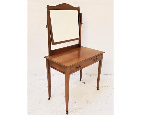 MAHOGANY AND INLAID DRESSING TABLEwith a shaped bevelled mirror back above a moulded top with a frieze drawer, standing on ta