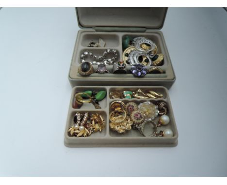 A small travel jewellery box containing a selection of costume jewellery including dress rings, earrings, cufflinks etc