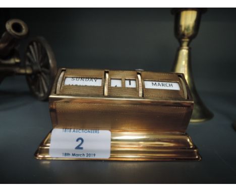A machine tooled perpetual date calendar with enamel numerals and lettering and brass body
