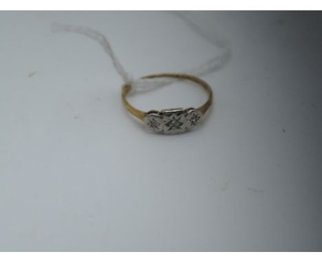 A lady's dress ring having three diamond chips in an illusionary setting on a yellow metal loop stamped 9ct &amp; plat,  size