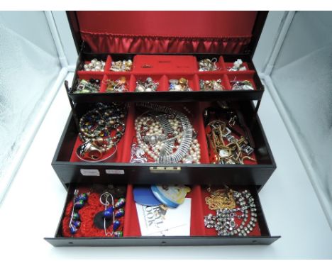 A jewellery box containing a selection of costume jewellery including earrings, watches Beryl Cook perspex brooches, perfume 