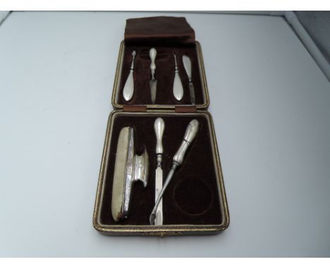 A cased part set of matched HM silver and white metal handled manicure tools, in box retailed by Goldsmiths &amp; Silversmith