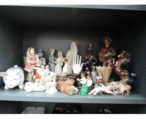 A selection of figures and figurines including ceramic piggy bank