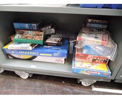 A shelf of modern games including Ridley's Magic Set, Junior Scrabble, Hanley's Chemistry Lab etc