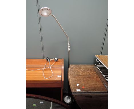 A modern brushed chrome effect standard lamp