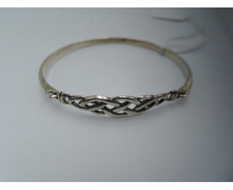 An white metal tension bangle stamped 925 having  Celtic decoration
