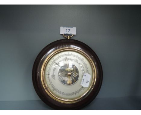 A small port hole barometer with oak caseCONDITION REPORT - IT APPEARS TO BE WORKING 