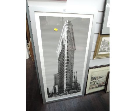 A black and white photographic print of the Flatiron Building by Henri Silberman