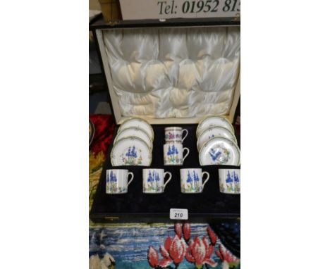 A Cased Tuscan China Coffee Set Comprising Five Cans and Six Saucers, One Replacement Oriental Rose Pattern Can