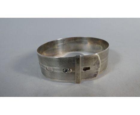 A Novelty Silver Bangle in the Form of a Belt with Engine Turned Decoration and Buckle Fastening, 24gms