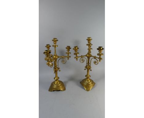 A Pair of Aesthetic Movement Gilt Brass Three Branch Candelabra with Central Candle Stick on Turned Supports with Three Scrol