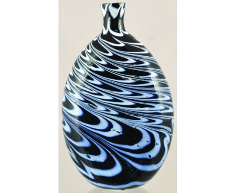 NAILSEA STYLE FLASK. 5ins tall. Dark olive green glass with white enamelled swirled decoration all round. Lip chip, but a gre