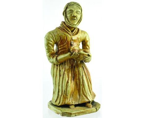 SALT GLAZE FIGURE. 8.5ins tall, light tan salt glaze. Similar figure to previous lot of an old lady holding basket of fruit. 