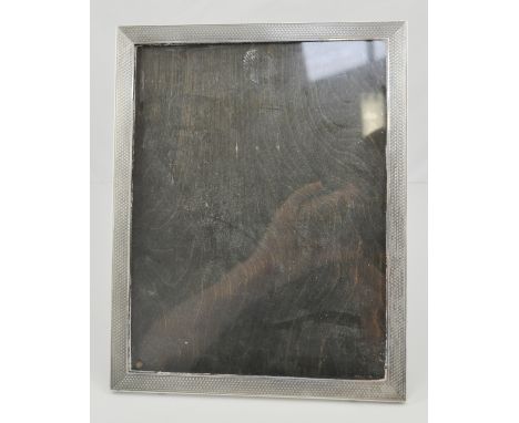 Rectangular photograph frame, engine turned, oak easel back, makers mark worn, Birmingham, 24cm x 19cm.