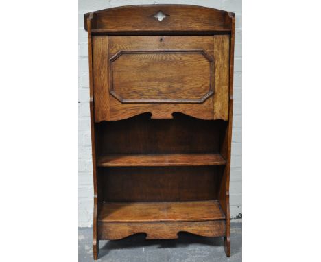 A narrow oak bureau, open shelf under.