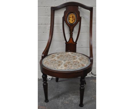 Edwardian mahogany nursing chair, arched back, pierced slat with later applied portrait, upholstered seat, turned and ringed 