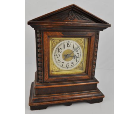 Oak cased mantel clock, triangular pediment, movement striking on a bell, height 25cms.