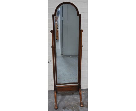 A cheval mirror, stained walnut frame.
