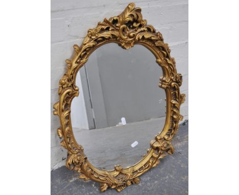 An oval wall mirror, gilt plaster frame.