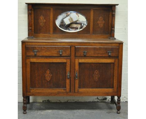 Oak sideboard with shallow mirror back.