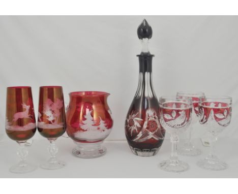 Ruby slice cut decanter, four similar pedestal wines, water jug and three glasses, (9)