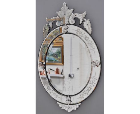 Venetian wall mirror, oval frame with a scrolled pediment, wheel engraved panels, 94cm x 56cm