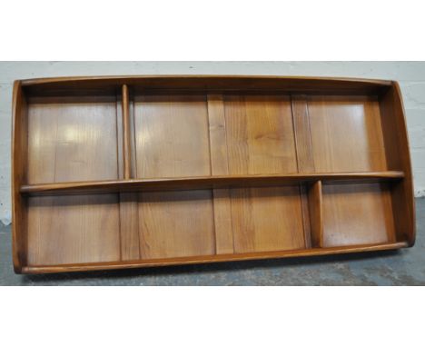 An Ercol wall mounted open shelf unit.