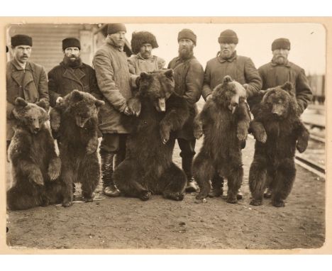 Bear Hunters. Three photographs of Russian bear hunters with their kills, gelatin silver prints, one dated 30.12.09 in the im