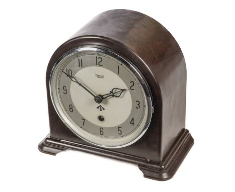 Military Clock. WWII period Bakelite mantel clock by Smiths, Enfield, the arched case with circular silvered dial, black Arab