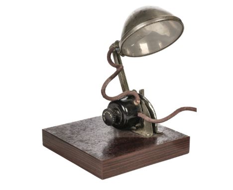 Avro Lancaster. A WWII Navigator's desk lamp, Air Ministry Type C, nickel finish with hinged arm and with black bakelite swit