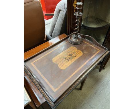 An Edwardian mahogany twin handled gallery tray, inlaid with musical instruments, together with an oak barley twist candlesti
