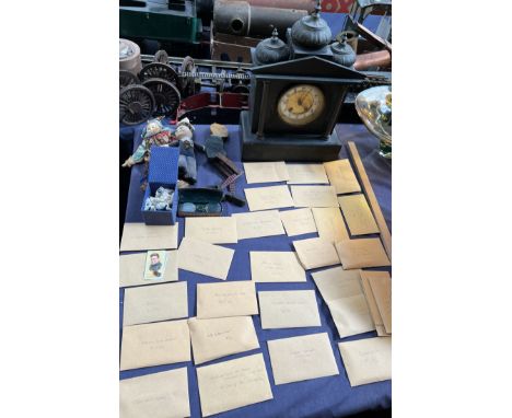 A black slate mantle clock together with Norah Welling dolls, cigarette cards etc 